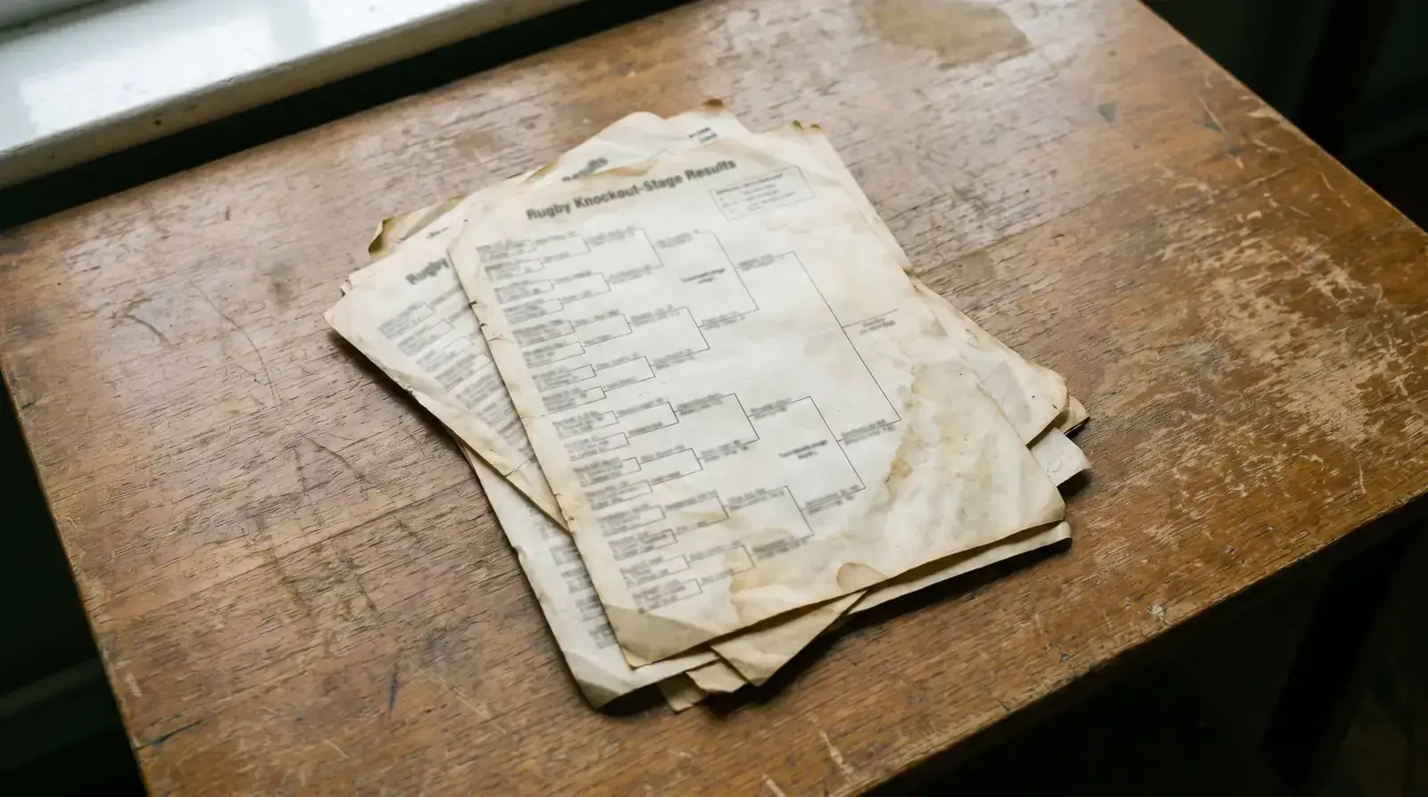 Archive papers showing past rugby knockout-stage results